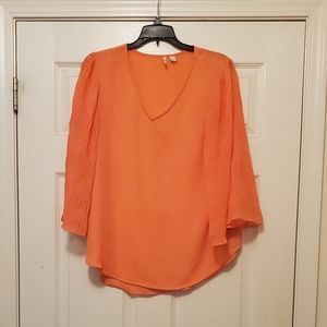 Ladies peach blouse with full, flattering sleeves